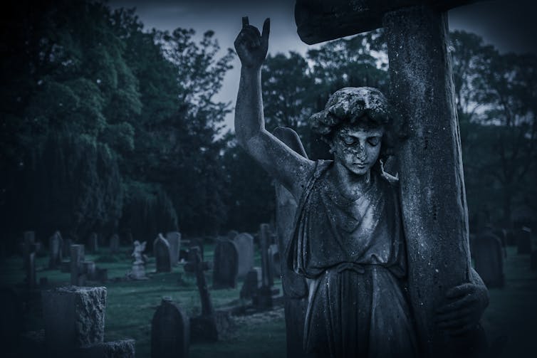 Crying angel statue in an old graveyard