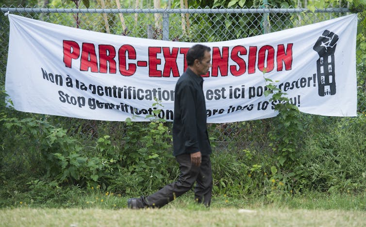 A man walks past a sign