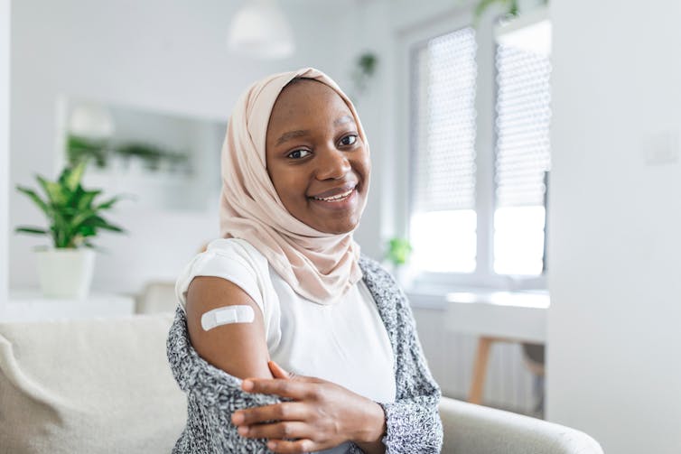 Person with bandaid after being vaccinated