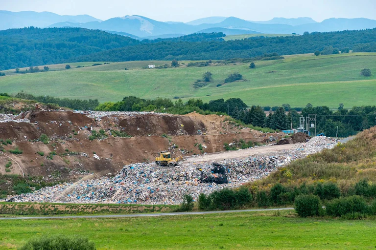 A landfill in the middle of green hills