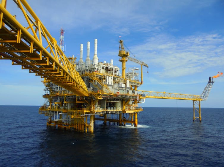 A yellow offshore oil and gas platform.