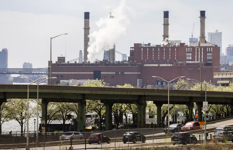 An urban landscape featuring a large red-brick power plant