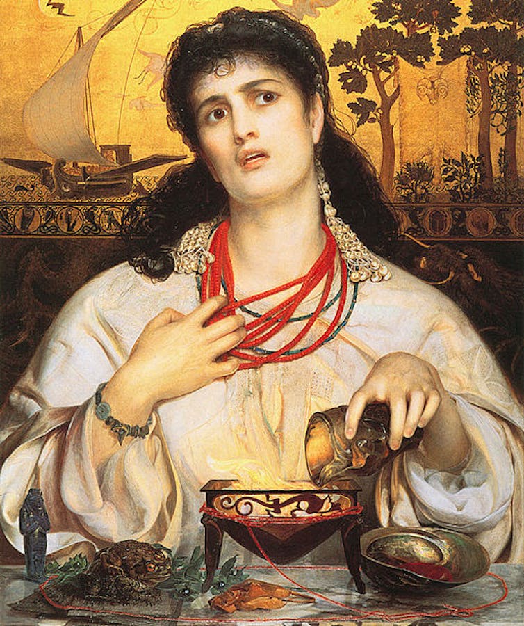 A woman looking deep in thought prepares a potion as a ship sails by in the background.