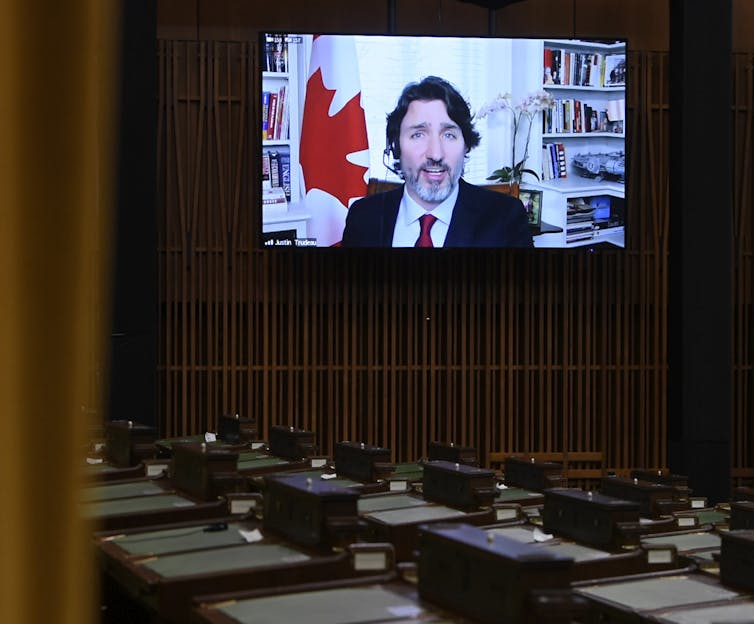 Justin Trudeau appears on a screen in the House of Commons