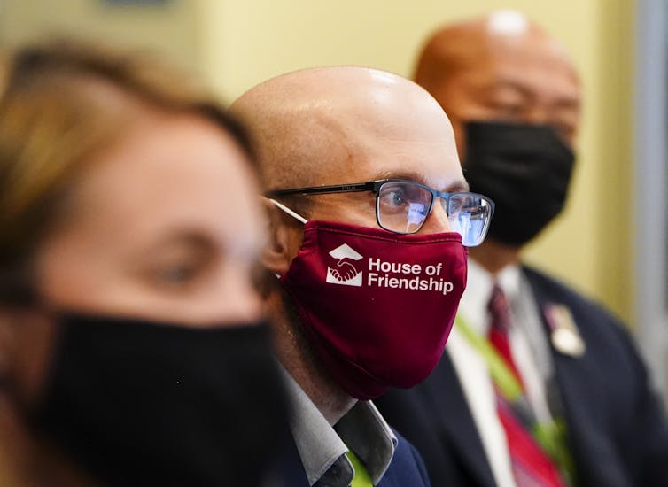 Three MPs wear masks and look ahead