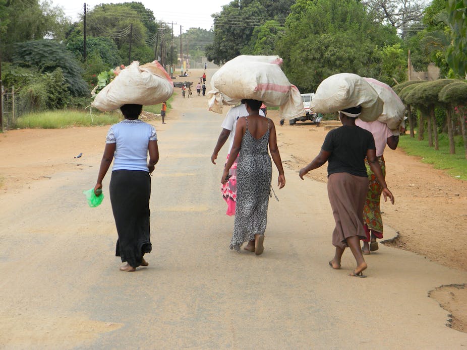 Woman walking with bags on their heads