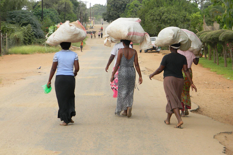 Woman walking with bags on their heads