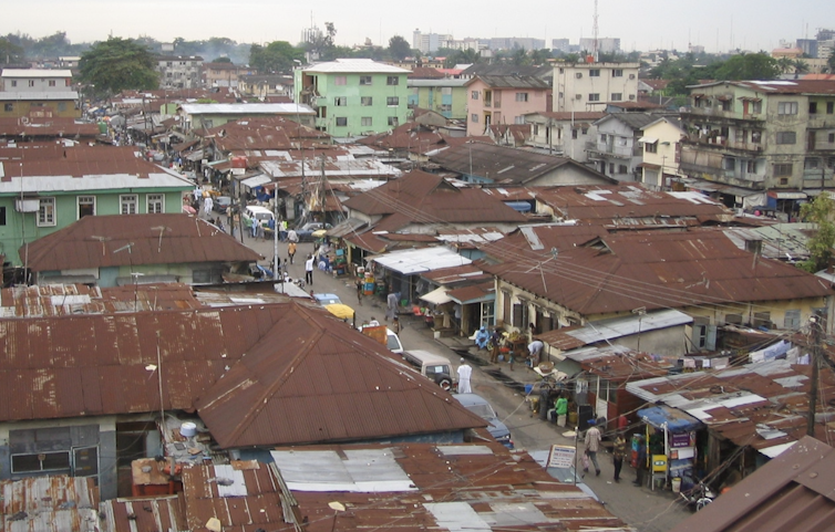 Birds-eye view of an African street packed with market stalls.