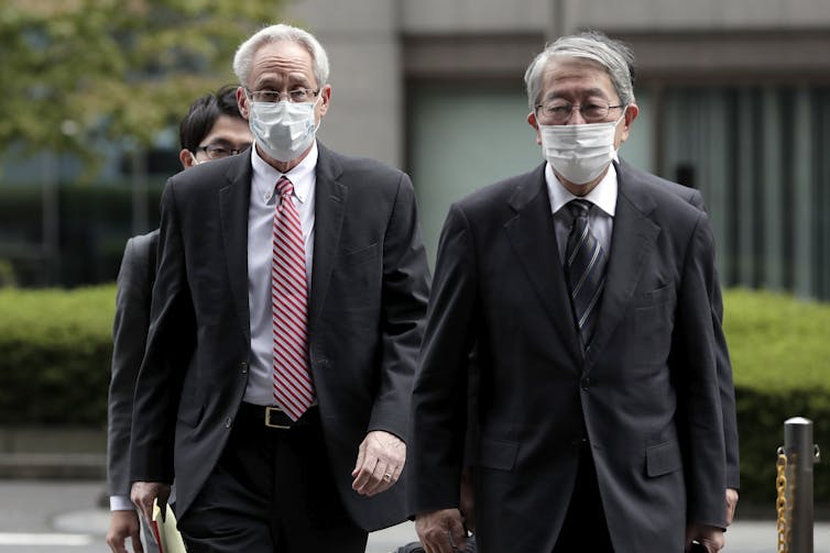 Former Nissan executive Greg Kelly (left) attending his trial in Tokyo.