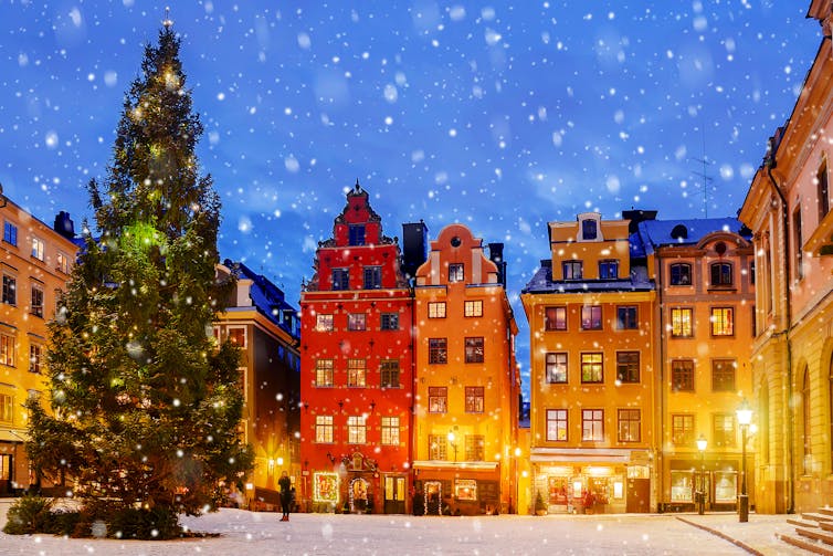 Tall houses in a town square at christmas