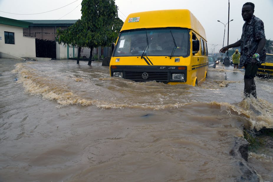 A public transport bus wades through a flooded road in Lagos, Nigeria.