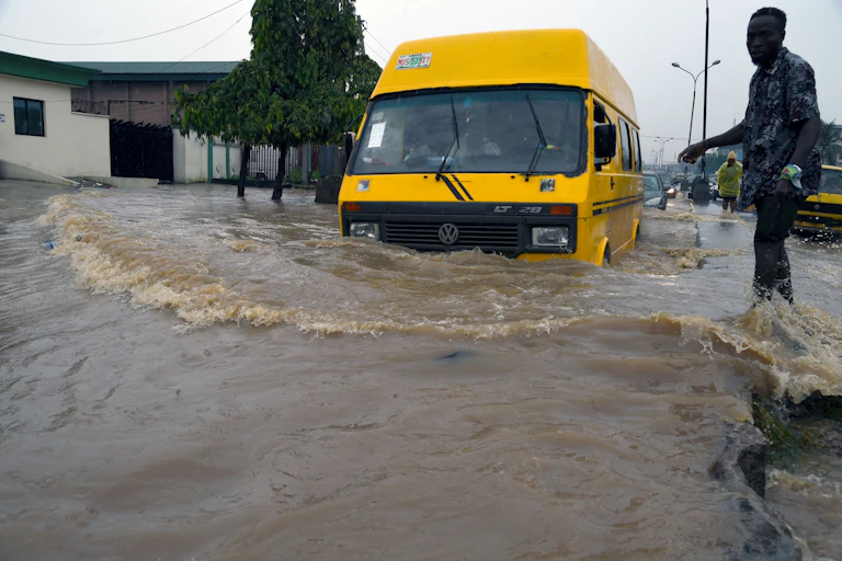 A public transport bus wades through a flooded road in Lagos, Nigeria.