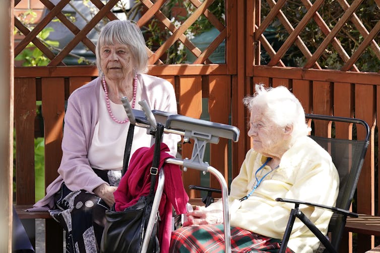 Two care home residents sitting outside
