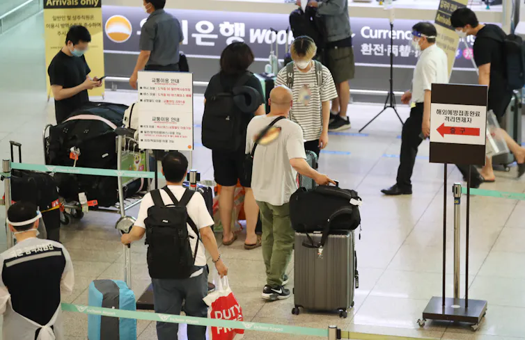 New arrivals queuing at a Korean airport