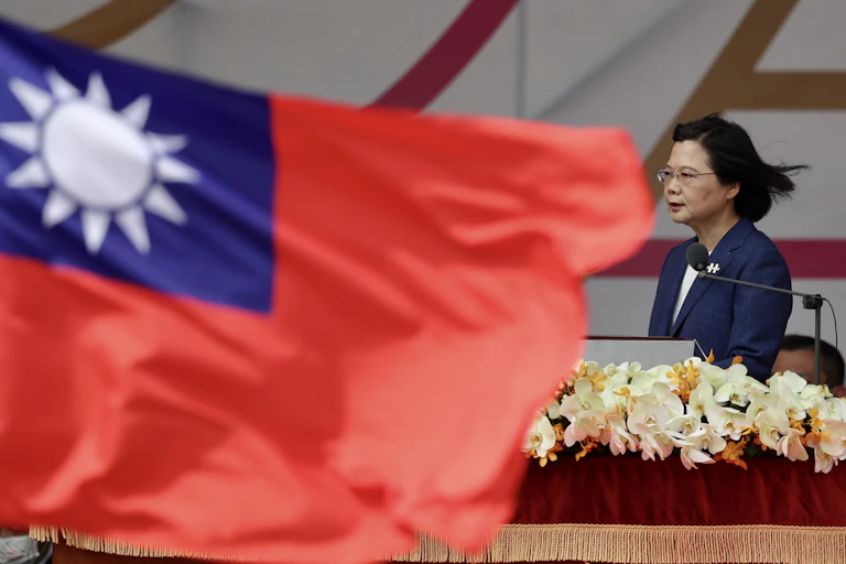 Taiwanese preisdent Tsai Ing-wen next to the flag of Taiwan.