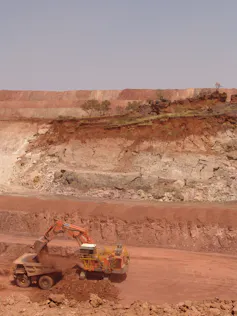 An open-cut manganese ore mine in front of a sacred Aboriginal site.