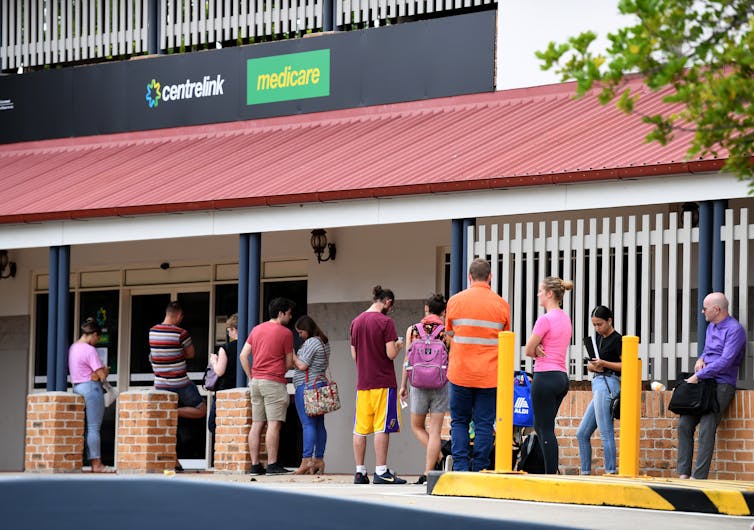 Job seekers line up outside a Cenrelink at the heigh for the COVID pandemic in March 2020