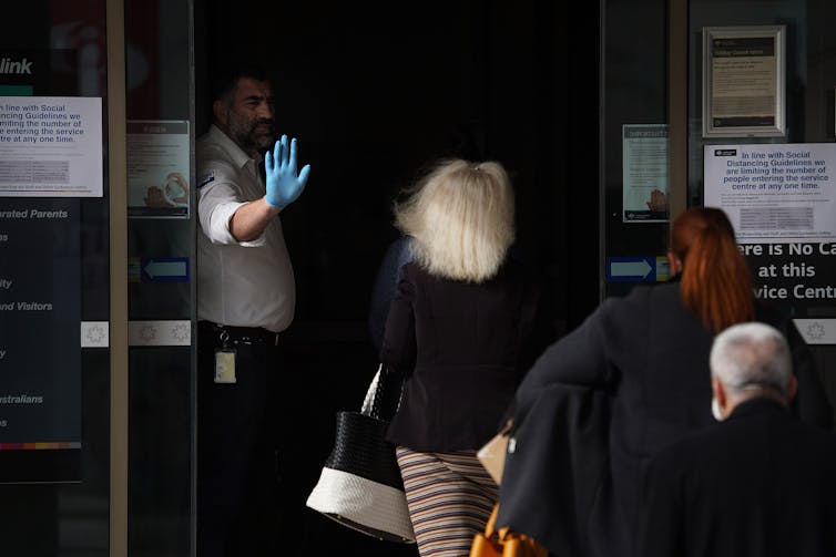 People lining up outside a Centrelink office.