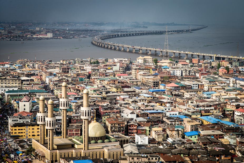 View of Lagos as a city with a suburb, water a bridge and a mosque.