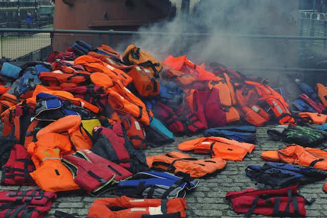 A heap of life vests on the floor.