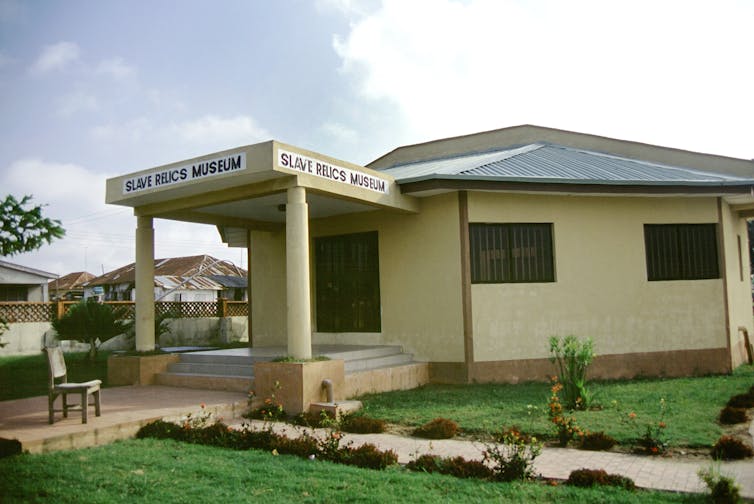 A yellow bungalow, with a lawn.