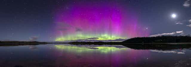 The Aurora Australis, or Southern Lights, reflected in the water.