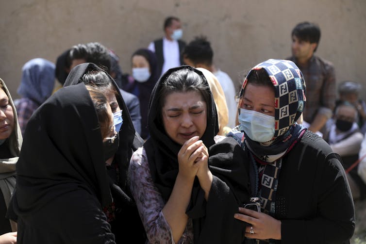 A group of Afghan women in mourning at a funeral.