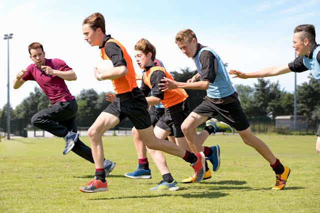 Teenage boys playing rugby