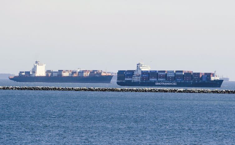 Cargo ships anchored outside of a port.
