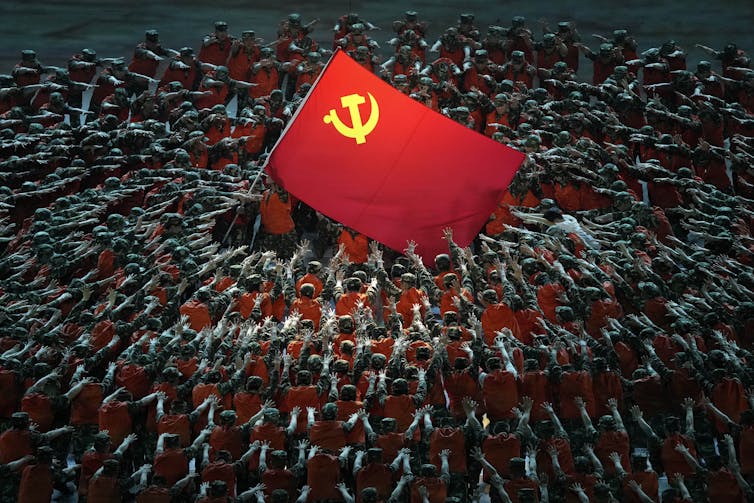 people surround CCP flag