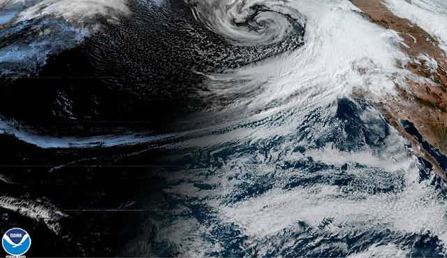 Heavy clouds spiral from the eastern Pacific to California.