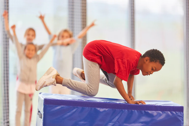 Other students cheer on boy in PE class