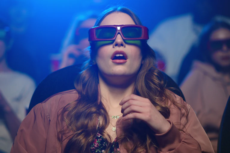 Image of a shocked woman feeling scared at cinema