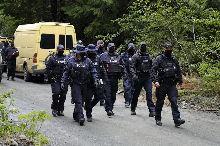 A group of RCMP officers walk down a street