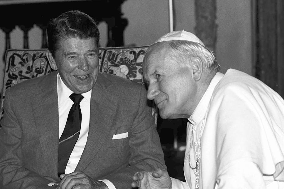 President Ronald Reagan sits and chats with Pope John Paul II.