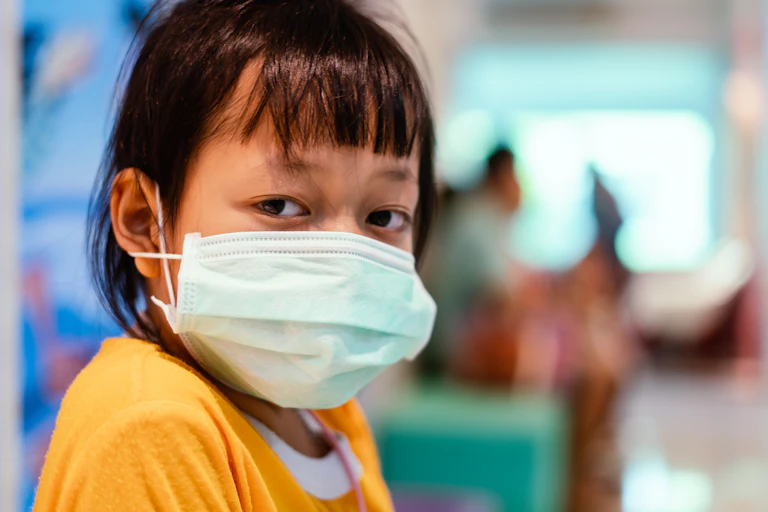 young girl with mask in hospital