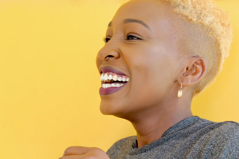 woman smiling on yellow background