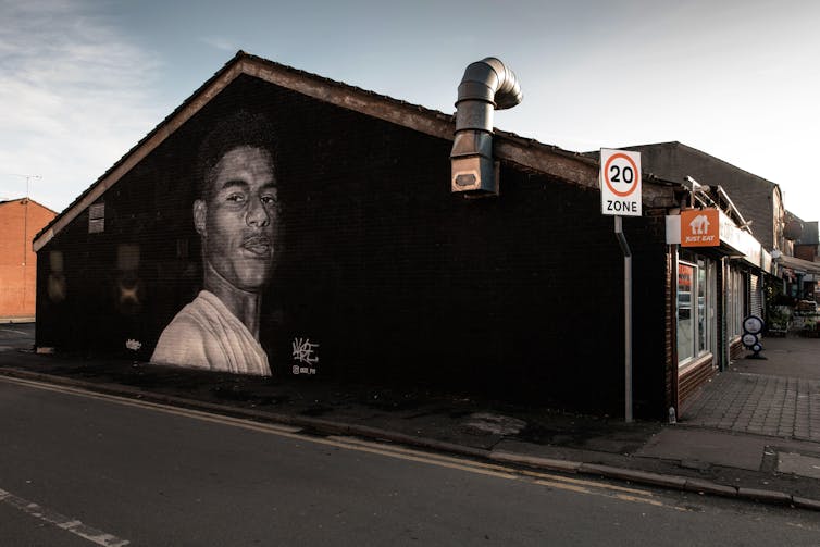 Mural of Marcus Rashford on side of a house