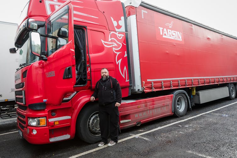 Driver standing outside his lorry