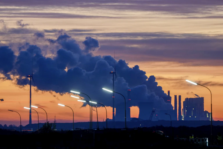 steam comes out of the chimneys of the coal-fired power station