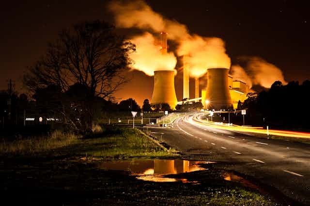 Power station at the end of a road at night