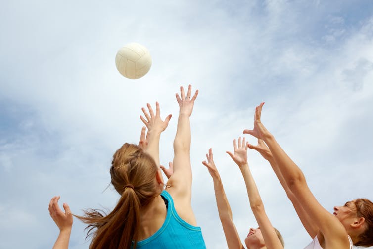 Teenage girls playing netball