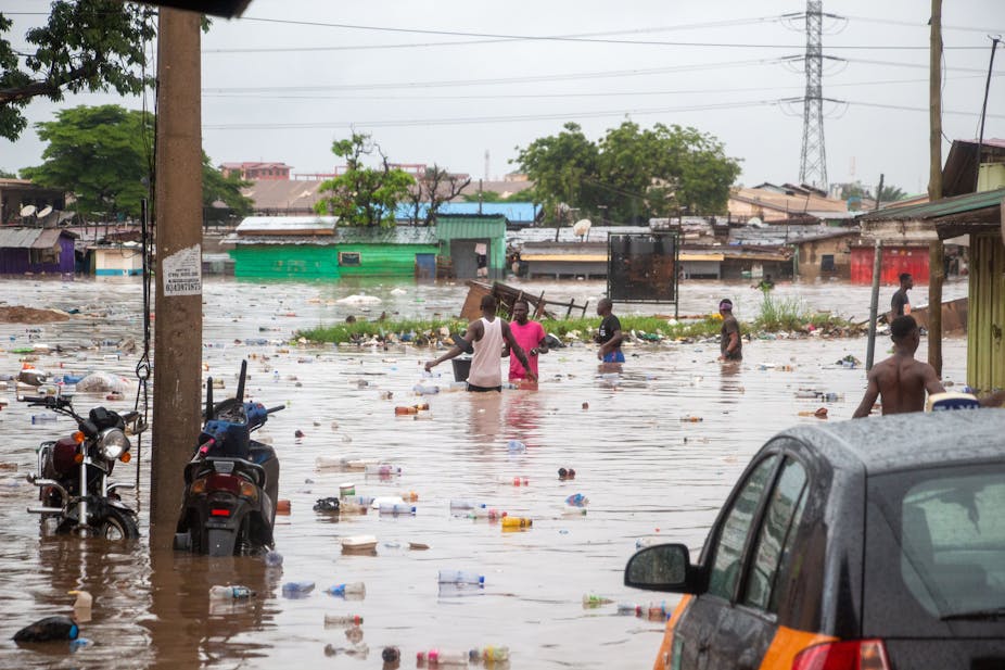 Residents contend with the flooding after a downpour in Accra, Ghana.