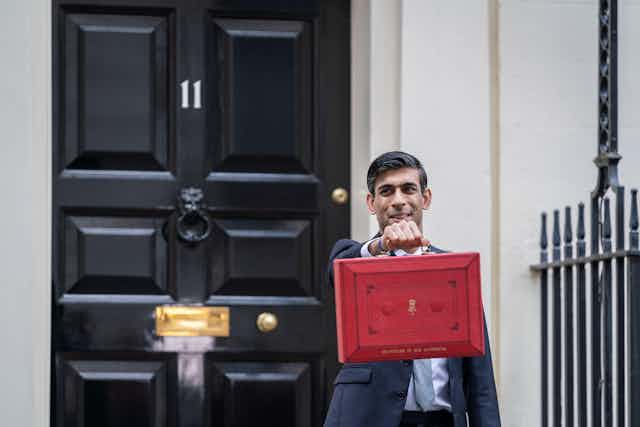 Rishi Sunak holding up the red briefcase