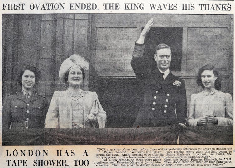 Newspaper picture of princess Elizabeth in army uniform with her parents and sister on a podium, smiling.