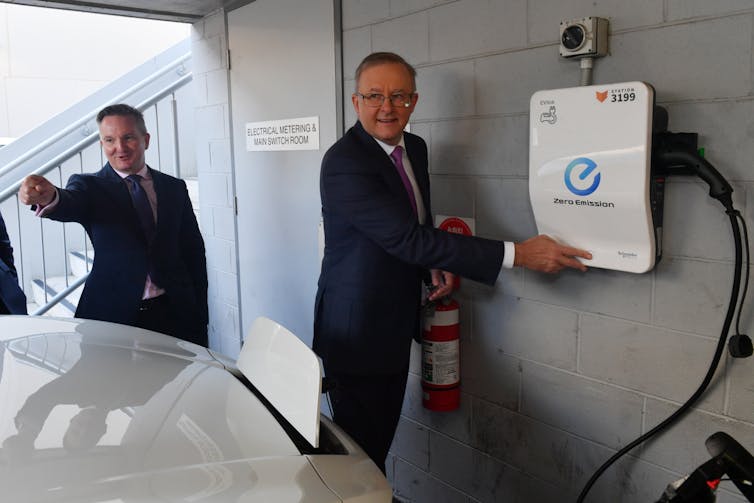 Chris Bowen and Anthony Albanese with an electric car.
