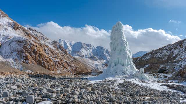 An ice stupa - an artificially created mini glacier - in the mountains of the Lahakh region.