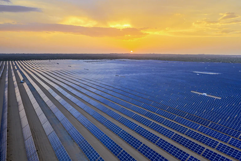 solar farm at sunset seen from above