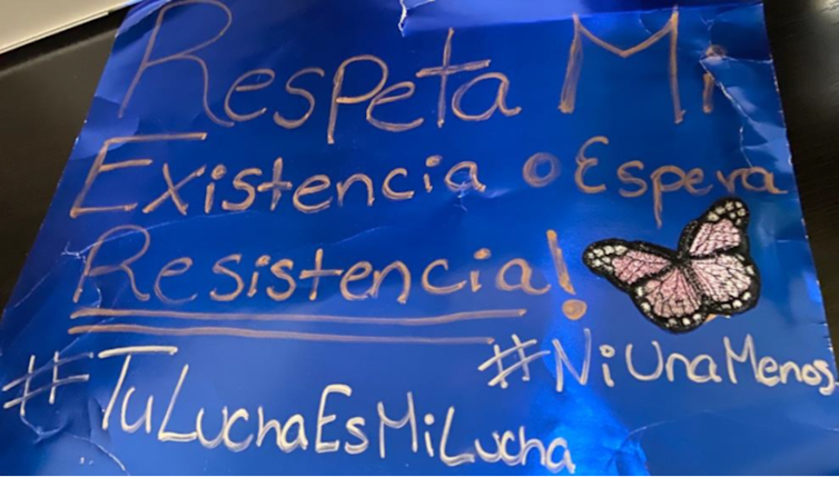 From the 'Picturing Our Realities' project, a blue poster that reads 'Respeta mi existencia oespera resistencia' which means 'Respect my existence or wait for resistence' in Spanish