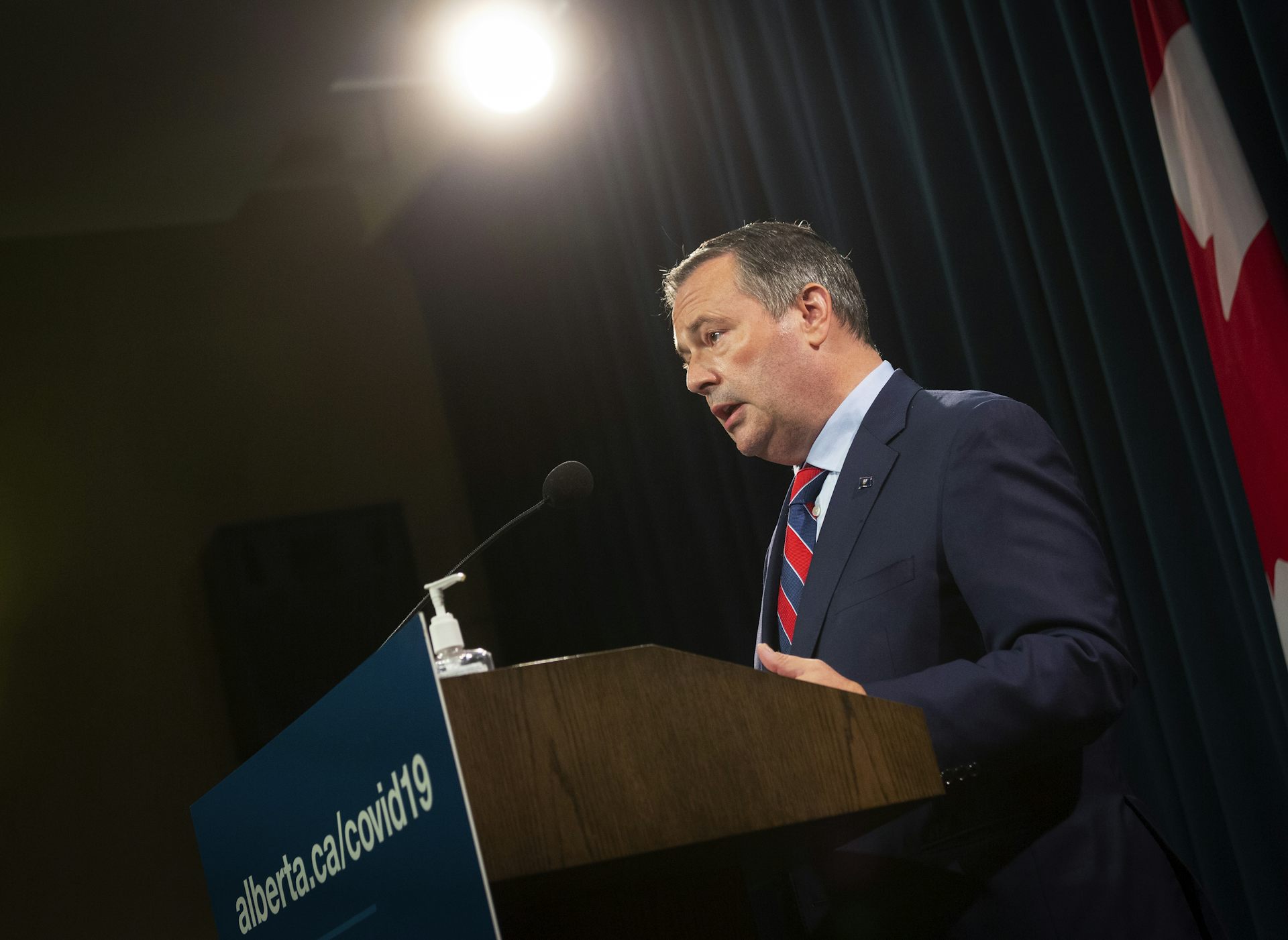 Jason Kenney answers questions at a news conference